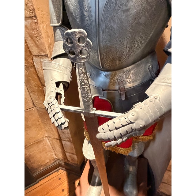 This full-size 15th Century replica suit of armour and sword stand atop a 9” leatherette display stand. The suit and sword...