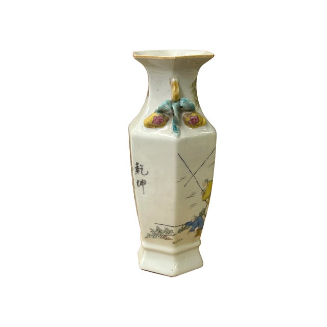This elegant hexagonal porcelain vase features a tapered body that expands toward the shoulders, topped with a flared,...