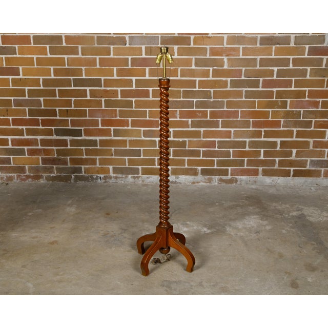 An English Turn of the Century oak floor lamp from circa 1900 with barley twist pedestal and quadripod base. This English...