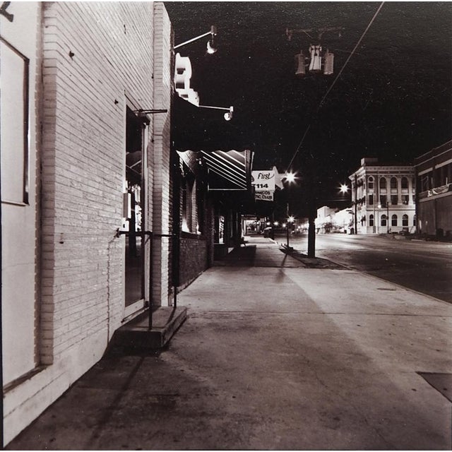 Pair of late 20th century black and white cityscape photographs of downtown San Marcos Texas at night by Eric C. Weller...