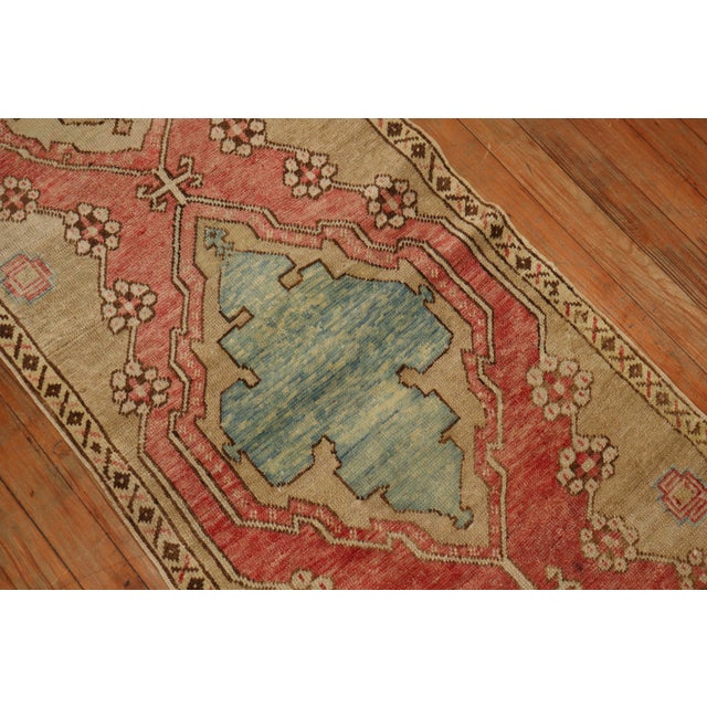 1940's Turkish Oushak Runner with a soft red ground accents in khaki, brown and light blue accents. Hand-knotted, one of a...
