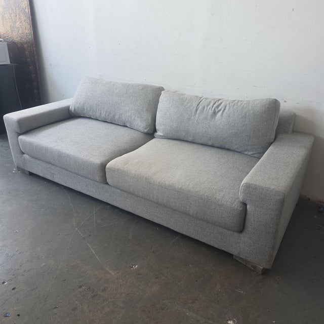 This Ben Soleimani 3-seat sofa offers a clean, modern look with its light gray fabric and square arm design. The cushions...