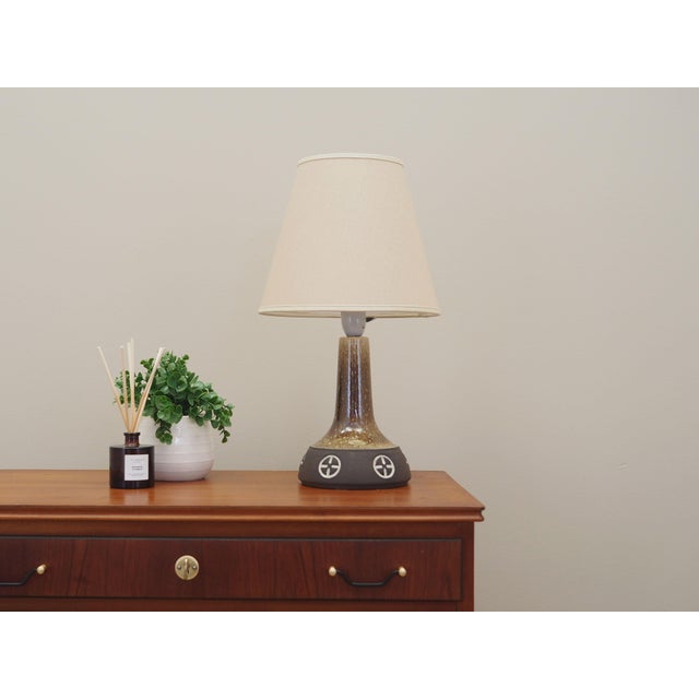 The lamp was made in the 1960s, produced by the well-known Danish manufactory Frank Keramik. The lamp is made of ceramics....