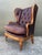 This exceptional vintage wingback chair is a distinguished marriage of French Provincial elegance and classic library...