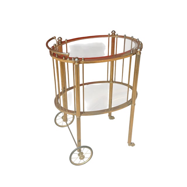 Exceptional vintage French brass and glass rolling bar cart, attributed to Maison Baguès, Paris, dating to approximately...