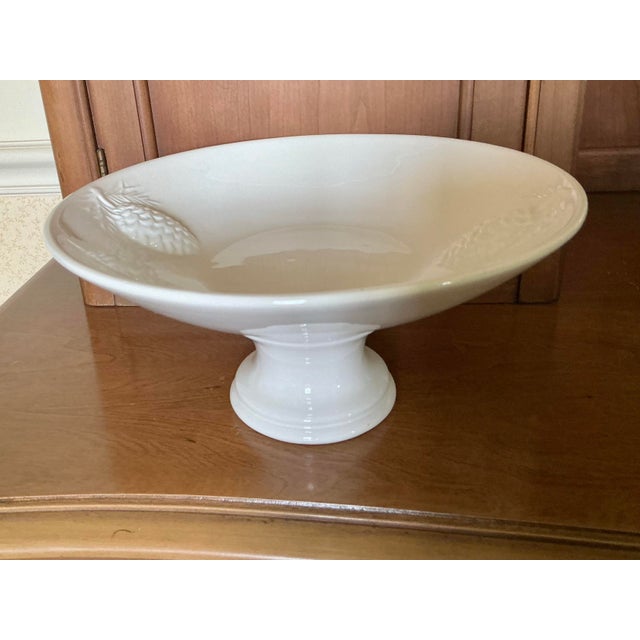 Vintage Italian glazed ceramic pedestal bowl with a shiny snow white finish. Featuring a wide, flared rim with embossed...