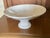 Vintage Italian glazed ceramic pedestal bowl with a shiny snow white finish. Featuring a wide, flared rim with embossed...