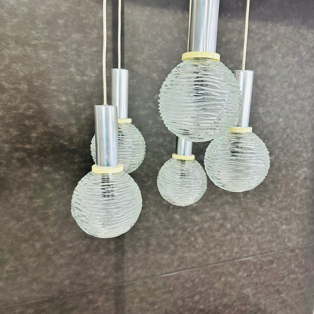 Dimensions: H 27.5” x W 17” Vintage Space Age Cascade pendant lamp with 5 embossed glass globe shades from the 1970s....