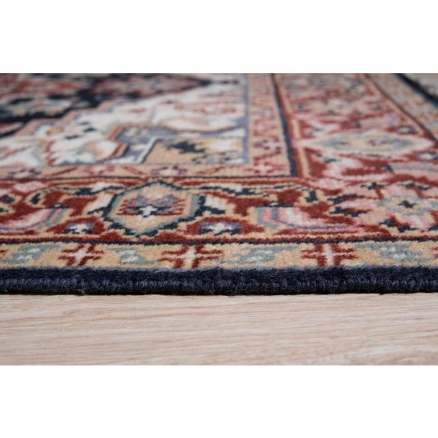 This blue wool rug is a hand knotted pile floor covering produced in India. It features a medium pile thickness that...