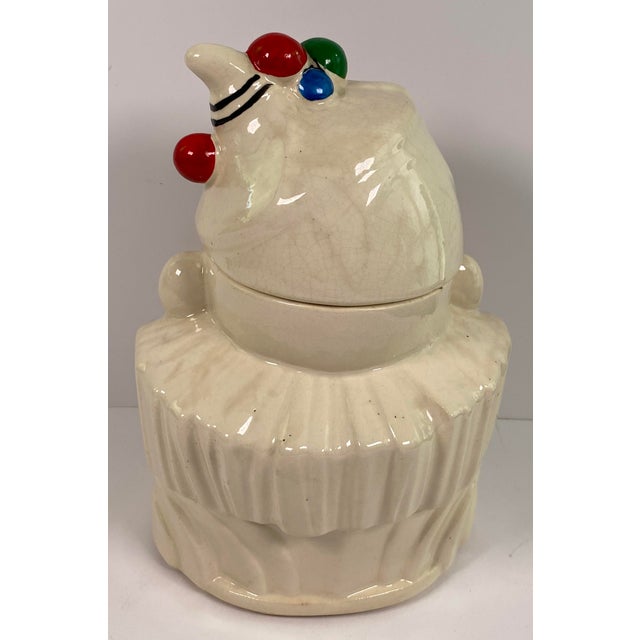 Add a touch of nostalgic charm and carnival whimsy to your kitchen or collection with this vintage ceramic clown cookie...