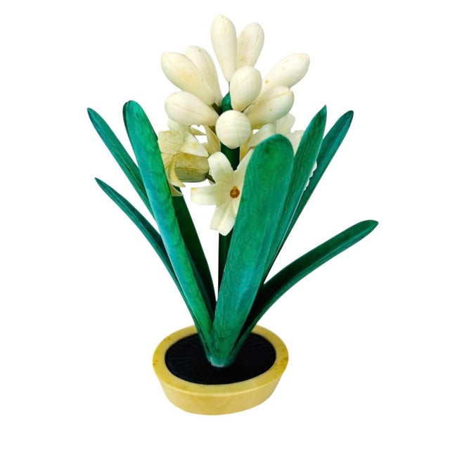 Hyacinth arrangement hand carved from a natural material. Potted in an oval shaped raised jardiniere. Hand colored.