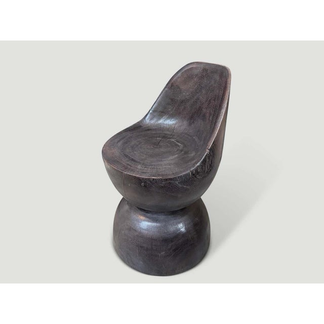 "Beautiful chair hand carved from a single block of wood. Charred to an espresso tone revealing the unique wood grain....