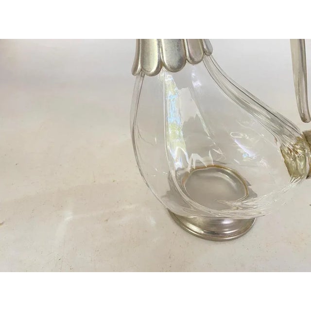 French Metal and Glass Liquor Bottle. It has been made in France during the 20th century. Silver color.