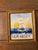 Charming vintage nautical artwork depicting a full-sailed ship cutting through deep blue waves beneath a softly colored...