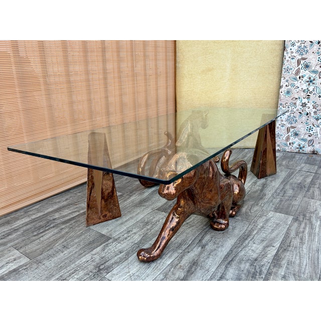 Vintage Hollywood Regency Mottled Bronze Ceramic Panthers Pedestal Glass Top Coffee Table. Circa 1970s Features a...