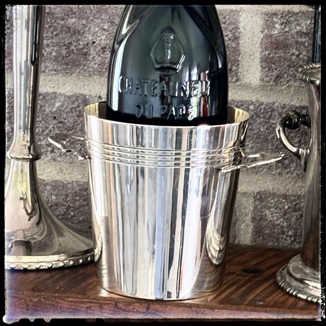 Add a touch of vintage elegance to your bar cart or table setting with this beautiful silver-plated small ice bucket....
