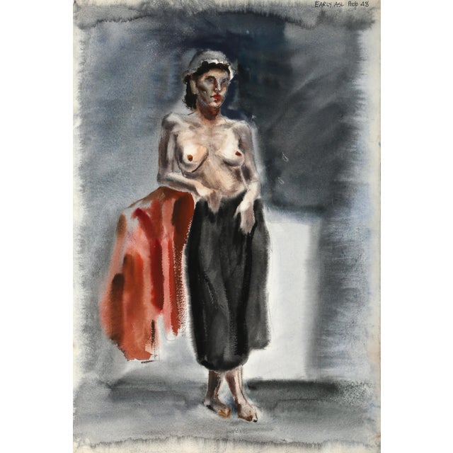 Leaning to the left, the topless model with brunette hair wears a high-waisted charcoal skirt as she crosses one foot in...