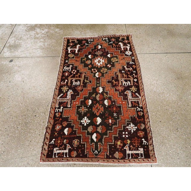 This early 20th century Turkish Anatolian rug, measuring 2' 8" x 4' 7", presents a bold tribal design with a dynamic...