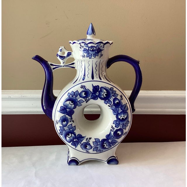 A sculptural delight in cobalt and cream, this vintage Russian Gzhel porcelain teapot transforms traditional function into...