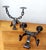 Wrought iron candlesticks, vintage Spanish work, in the brutalist style. Resting on four notched feet, two arms forming...