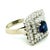 A classic vintage sapphire and diamond ring with a beautifully balanced, structured design. At the center sits a deep blue...