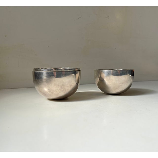 A polished stainless steel egg in super-elliptical shape. Originally designed by Piet Hein in 1956 in sterling, silver-...