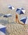 Girl On The Beach by Toni Frissell Beachwear fashion shoot featuring a model on a sandy beach wearing a swimsuit and a...