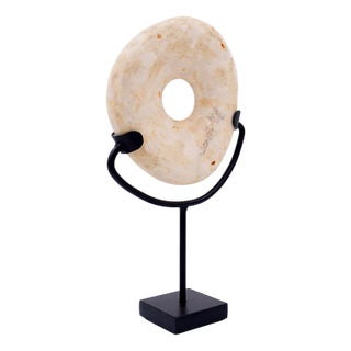 Wamayuwa Boiken Coin in Hand-Carved Shell Mounted on a Black Metal Stand For Sale