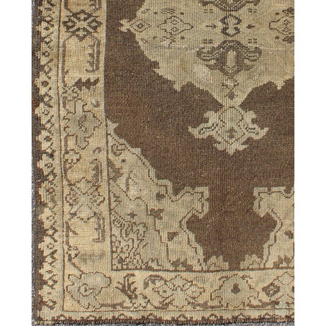 Measures: 3'6 x 5'6. Chocolate background vintage Turkish Oushak rug with floral medallion in cream. Keivan Woven Arts /...