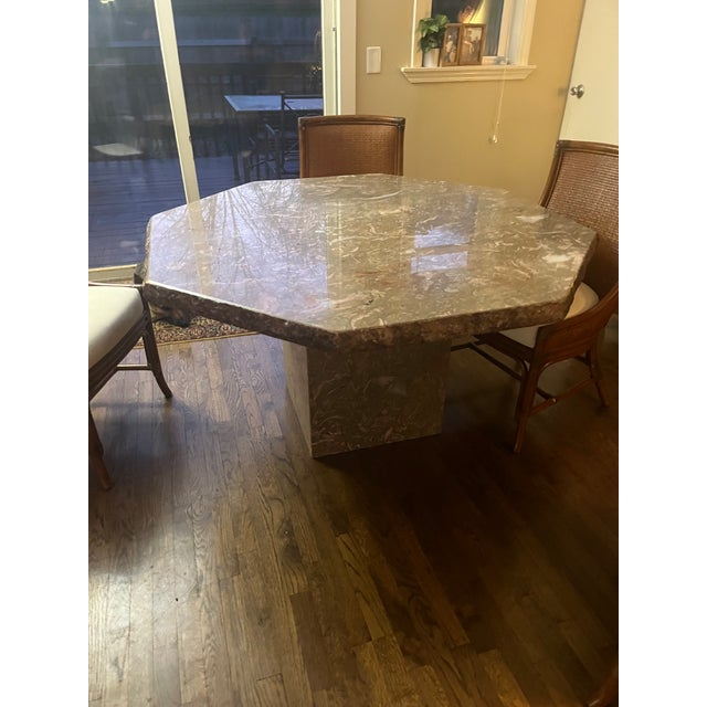 Stone International Italian marble dining table with a striking octagonal top and substantial pedestal base. Crafted in...
