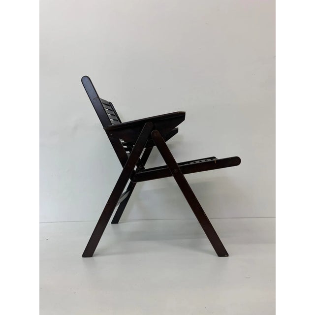Dimensions: 56cm W, 43cmD seat, 58cmH armrest, 74cmH total, 58cmD total Condition: Good Material: Wood