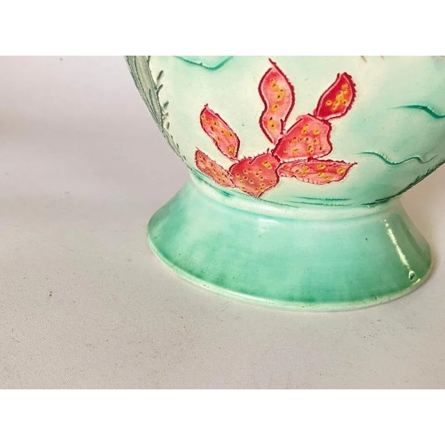 It is a ceramic vase, which has been painted by hand. It is signed by the artist, and dated circa 1970. This vase was made...
