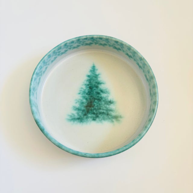 A large vintage art pottery bowl by Pysht Pot. Green and pale gray glazes featuring the image of an evergreen tree in the...