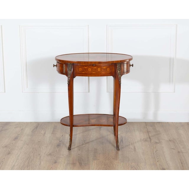 An exquisite Napoleon III side table, late 19th century, richly decorated with intricate marquetry and fine bronze mounts....