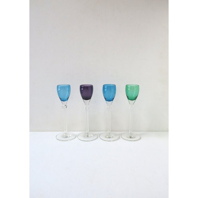 A beautiful set of four (4) colorful crystal aperitif or cordial glasses with teardrop cut design, circa mid-20th century....