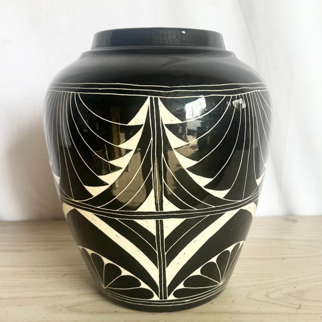 This striking 1989 sgraffito pottery vase by the Curras Brothers exemplifies bold graphic artistry and refined handcraft....