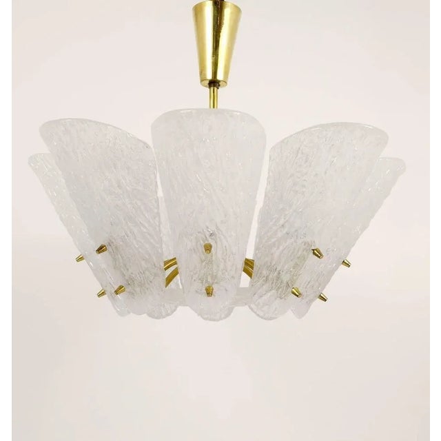 A beautiful brass chandelier by Kalmar Vienna from the 1950s. Has lovely spoon-shaped, textured glass lampshades. In good...