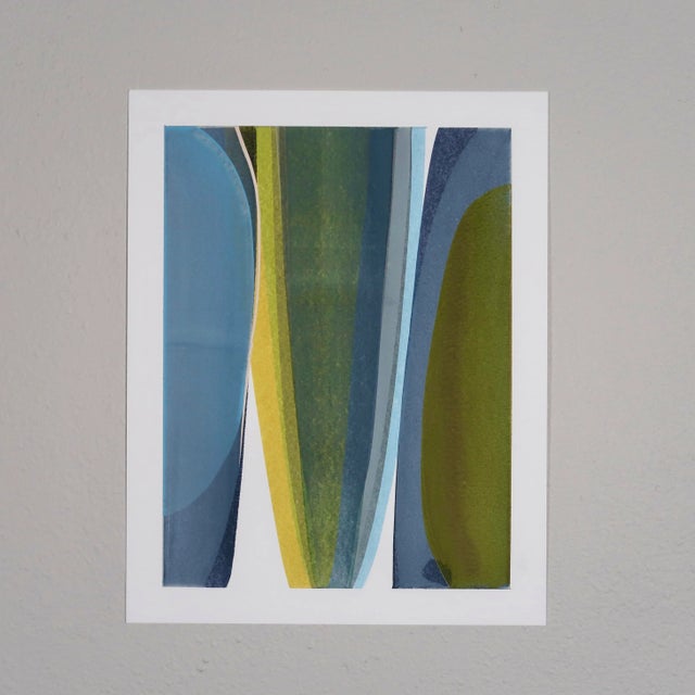 This original abstract painting on paper features soft, overlapping forms in hues of blue, olive green, mustard yellow,...