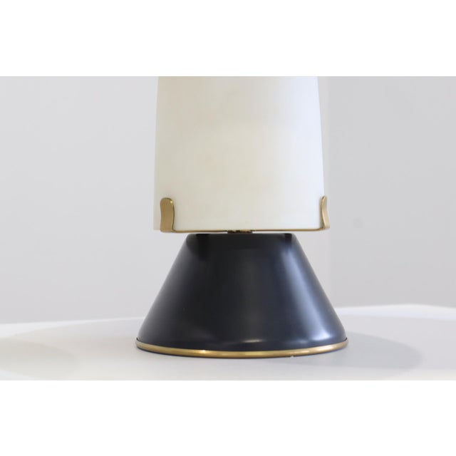 Opal glass and lacquered metal diffuser, lacquered metal base, and brass details. Original label. Produced by Stilnovo,...