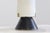 Opal glass and lacquered metal diffuser, lacquered metal base, and brass details. Original label. Produced by Stilnovo,...