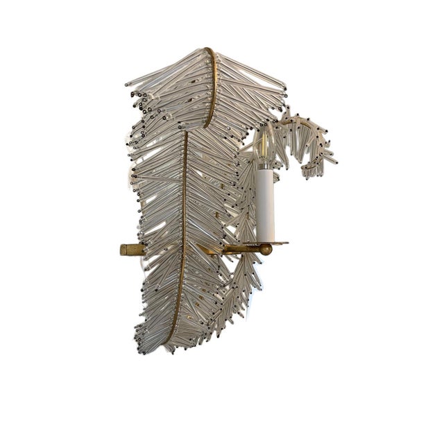 A striking pair of sculptural wall sconces by Visual Comfort, designed in the form of stylized wings and executed in an...