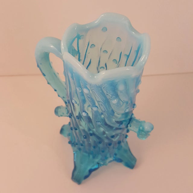 Pattern: Town Pump Color: Blue Opalescent Manufacturer: Northwood Glass Company Date Produced: 1899 Shape: Creamer Novelty