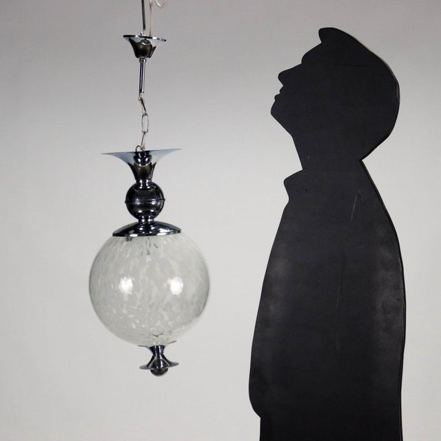 Group of 2 ceiling lamps, chromed metal and glass. This piece is attributed to the mentioned designer/maker. It has no...