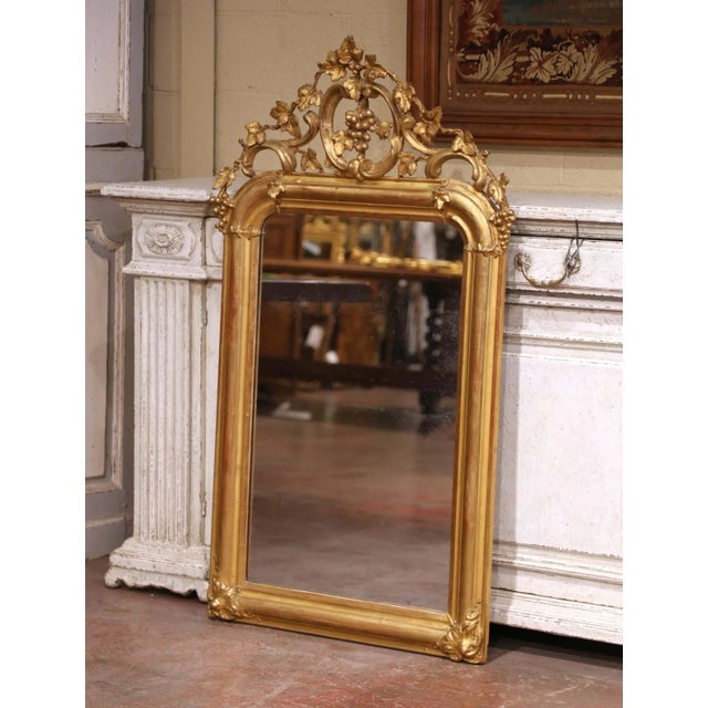 This elegant antique wall mirror was crafted in France circa 1870 and displays the graceful curves and exuberant ornament...