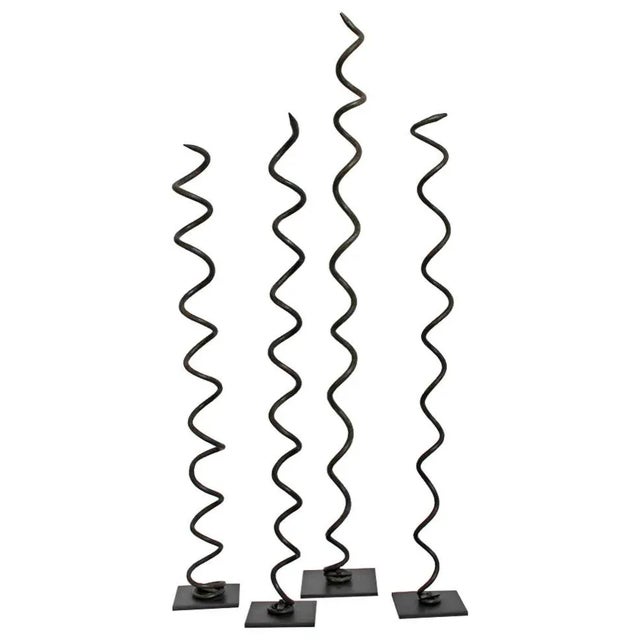 Original Igbo copper and bronze twisting coil currency. Shaped into snakelike designs and mounted on iron stands. Sold...