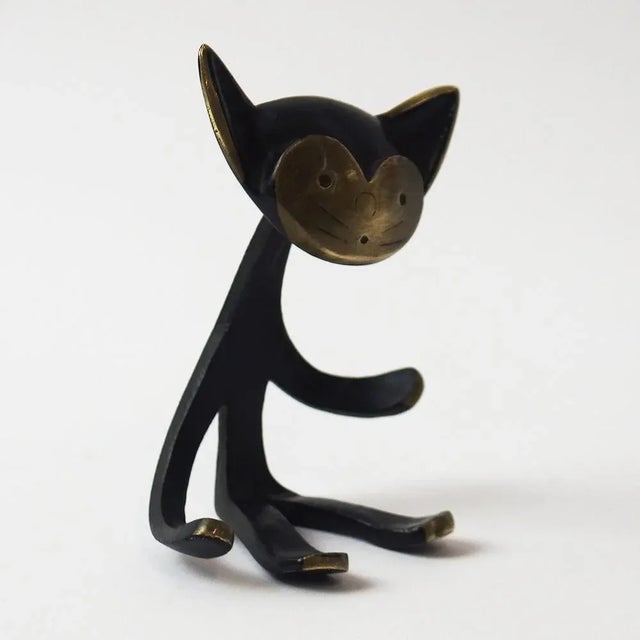 Carte holder representing a stylized cat. Brown and gold patina bronze created by Walter Bosse for Herta Baller This piece...