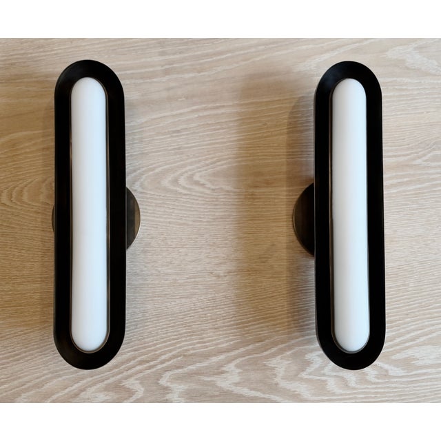 A striking pair of Circuit 1 wall sconces by acclaimed New York design studio Apparatus, executed in their Blackened Brass...