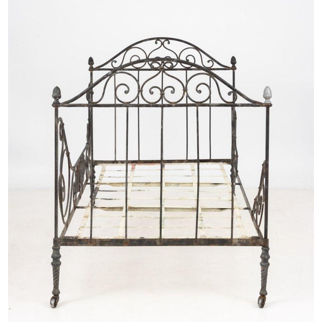 French Wrought Iron Daybed, 19th century, atop casters. 46.5" H x 74.5" W x 40.25" D. Provenance: From the Collection of...
