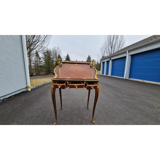 writing desk/Table with curved sides and carved legs. New reproduction. Cherubs holding candelabra on the front corners....