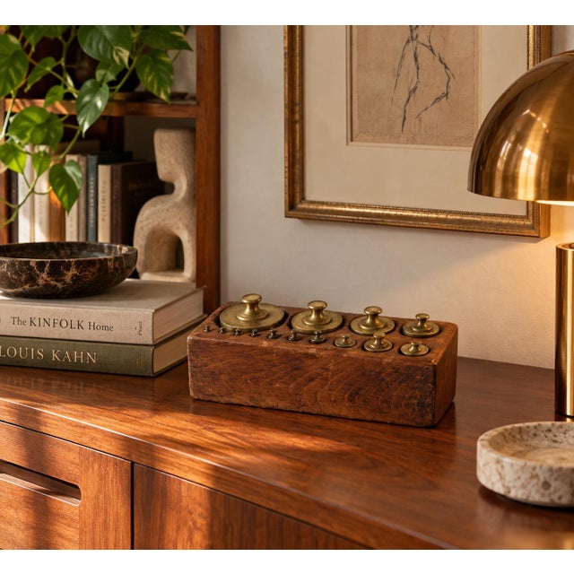 A charming 19th-century French scale weight set featuring a graduated collection of solid brass weights housed in its...